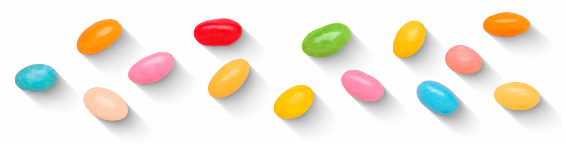 Rozsypane pastelowe fasolki jelly beans na białym tle rzucające cień